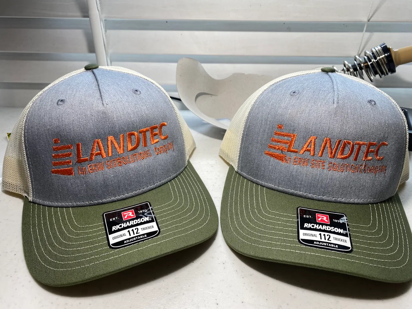 Custom embroidered trucker hats for Landtec corporate apparel in Austin TX