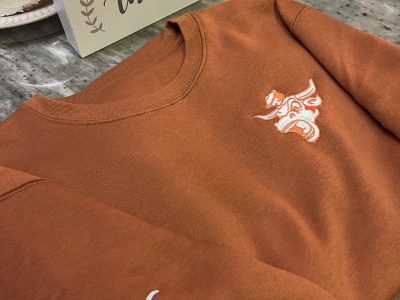 Burnt orange custom embroidered fleece sweater for local client in Austin TX