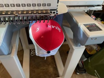 Professional commercial hat embroidery machine in action in Austin TX
