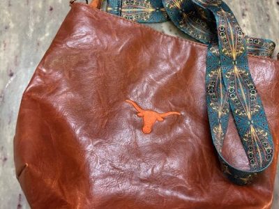 Custom embroidered leather purse featuring Longhorn logo design